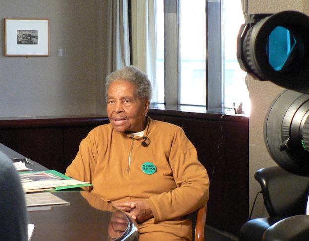 Person sitting in front of camera talking while sitting in a chair
